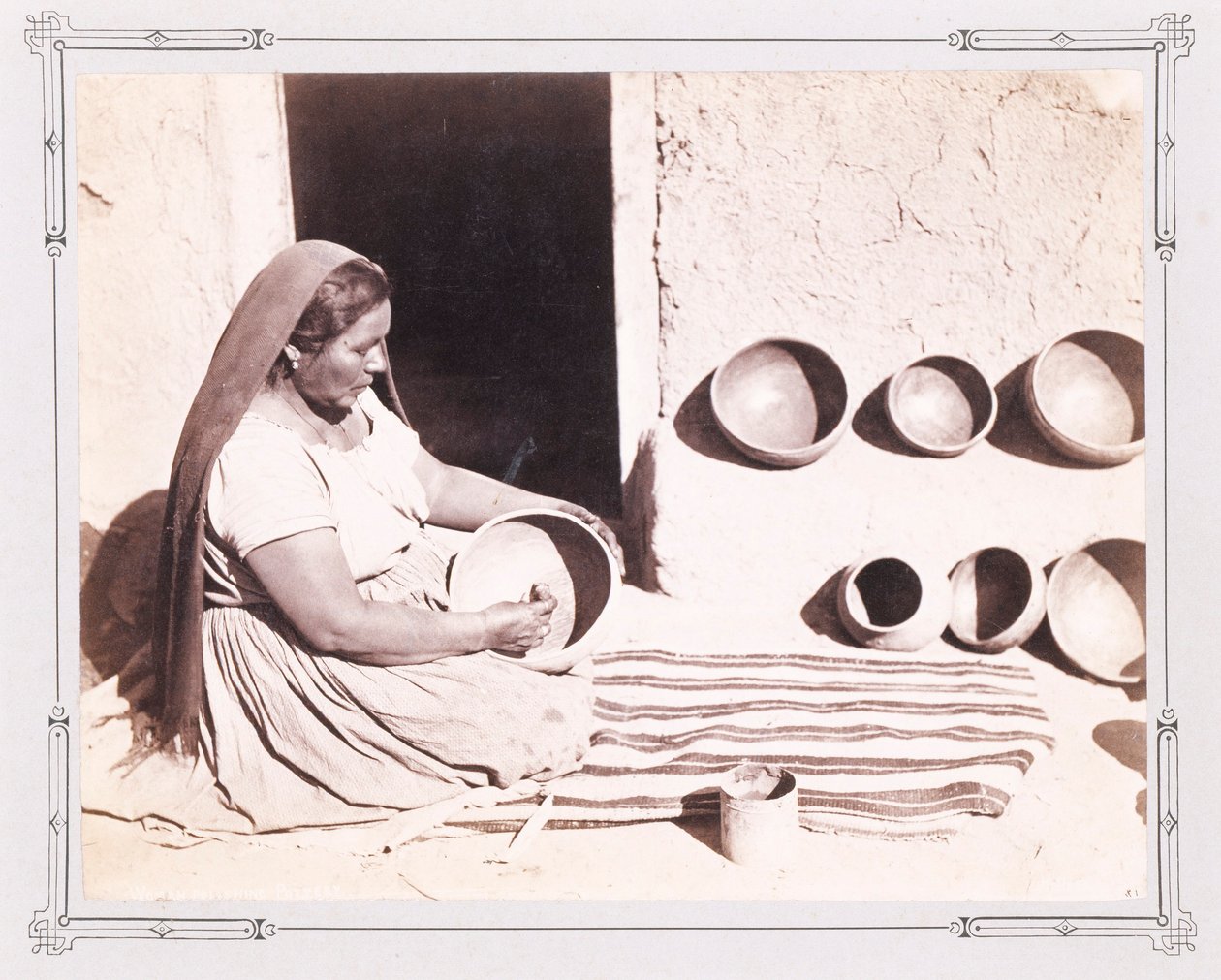 Frau beim Polieren von Keramik von John K. Hillers