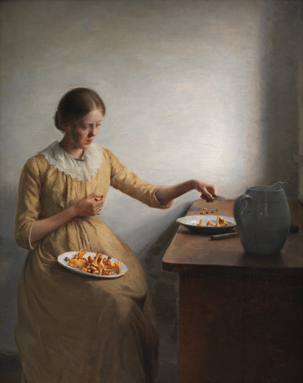 Ein junges Mädchen bereitet Pfifferlinge vor von Peter Vilhelm Ilsted